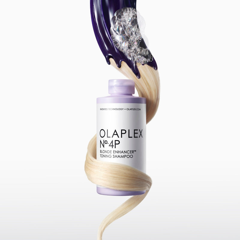Blonde hair wrapped around a bottle of OLAPLEX No.4P Blonde Enhancer™ Toning Shampoo
