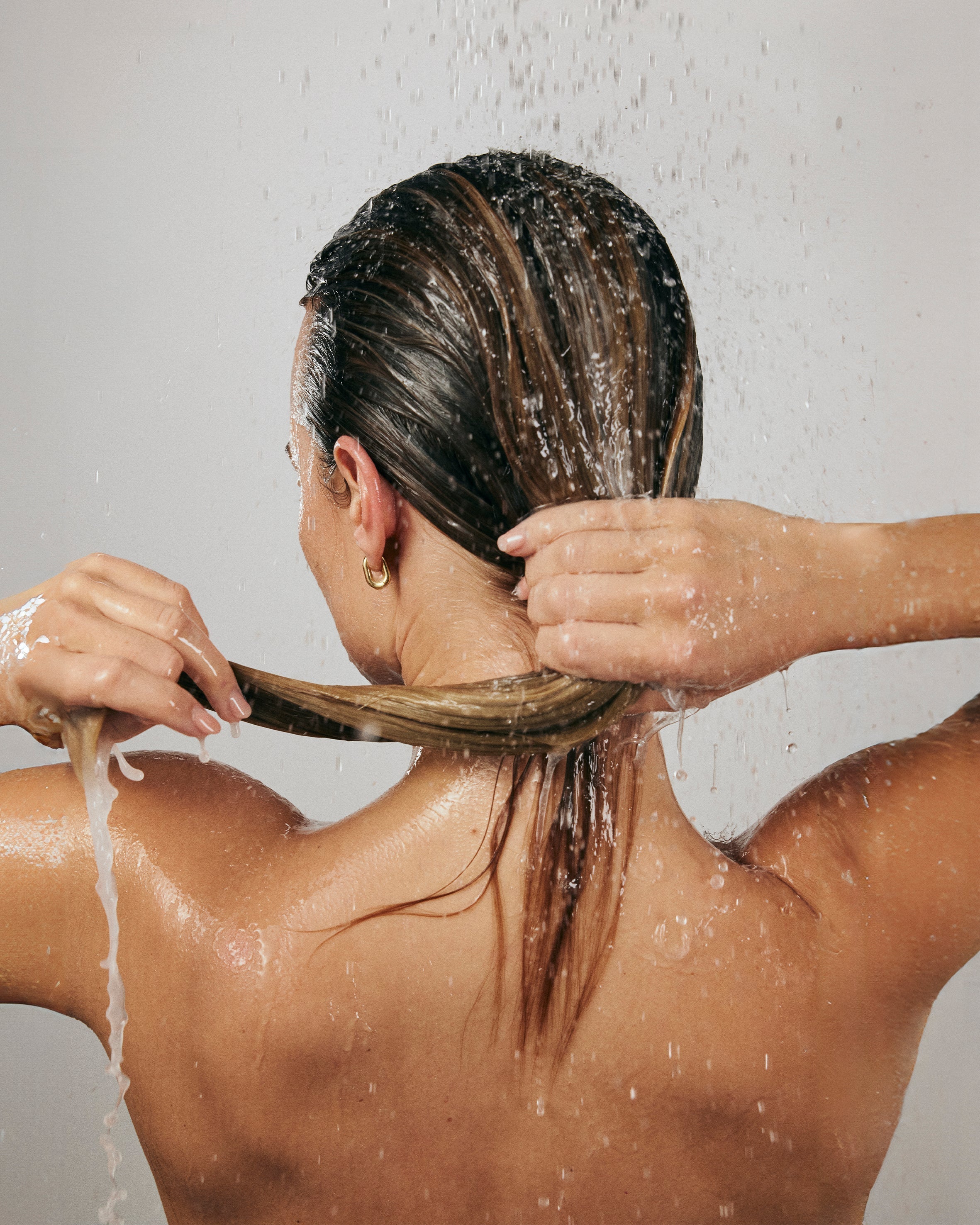 Woman finger combing through wet hair
