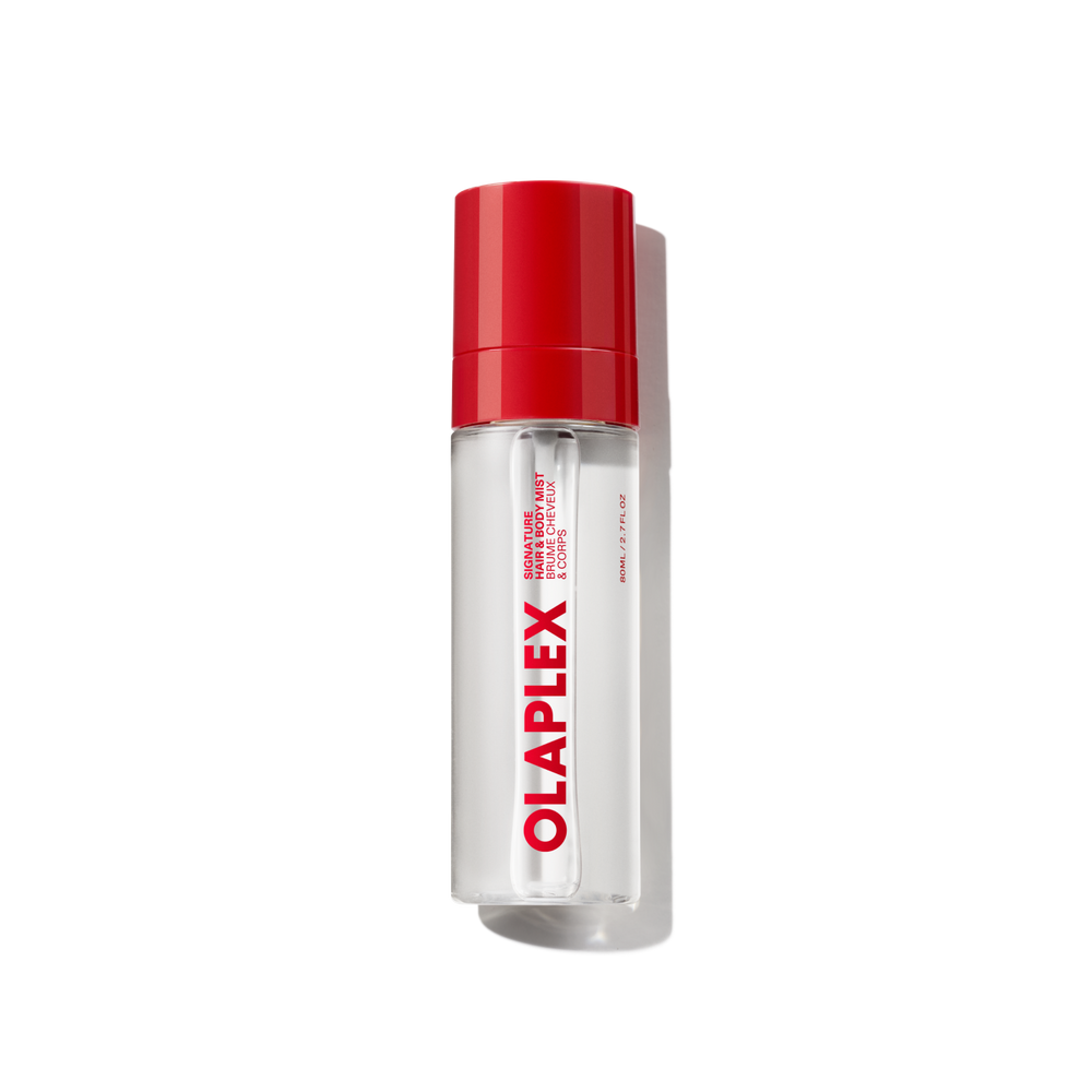 A clear bottle of Olaplex Hair and Body Fragrance Mist featuring a vibrant red cap and the bold Olaplex logo printed vertically down the front, shown against a transparent grid background. - main view