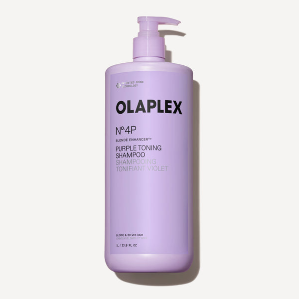 A one-liter bottle of Olaplex No. 4P Blonde Enhancer Purple Toning Shampoo with a pump dispenser, centered against a clean white background. - main view