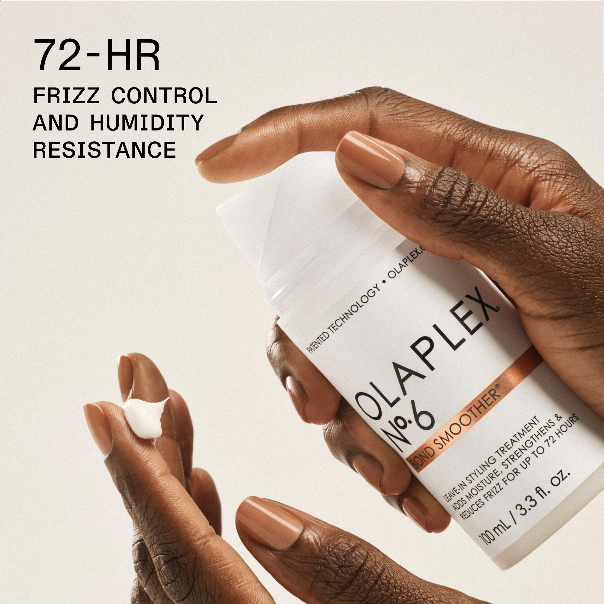 A close-up shot of a person's hand with brown-painted nails holding a white bottle of "OLAPLEX N°.6 BOND SMOOTHER® LEAVE-IN STYLING TREATMENT (100 mL / 3.3 fl. oz.)". In the lower-left corner, a small dollop of the white cream rests on the person's fingertips. Bold black text in the upper-left corner reads "72-HR FRIZZ CONTROL AND HUMIDITY RESISTANCE".
